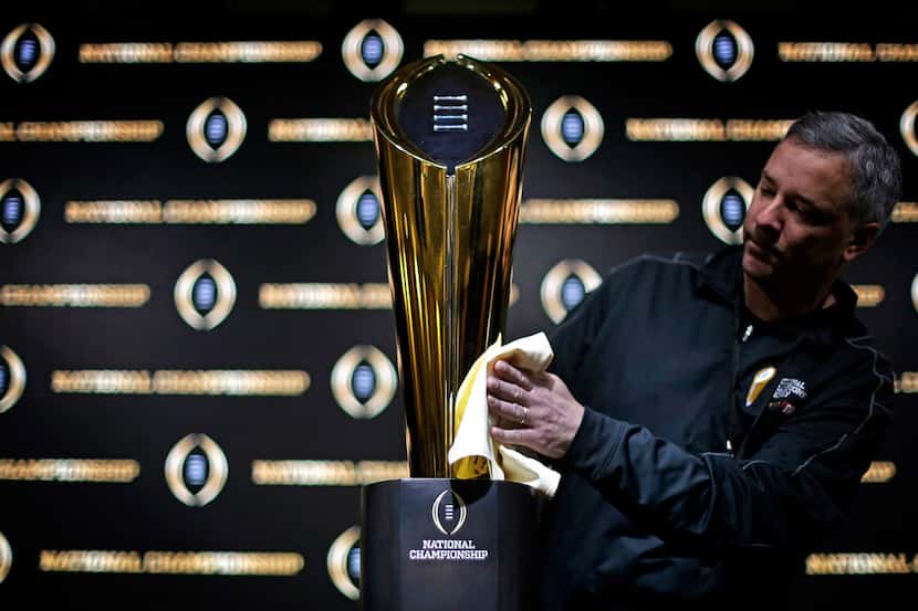 FILE - In this Jan. 7, 2018 file photo Charley Green buffs the NCAA college football...