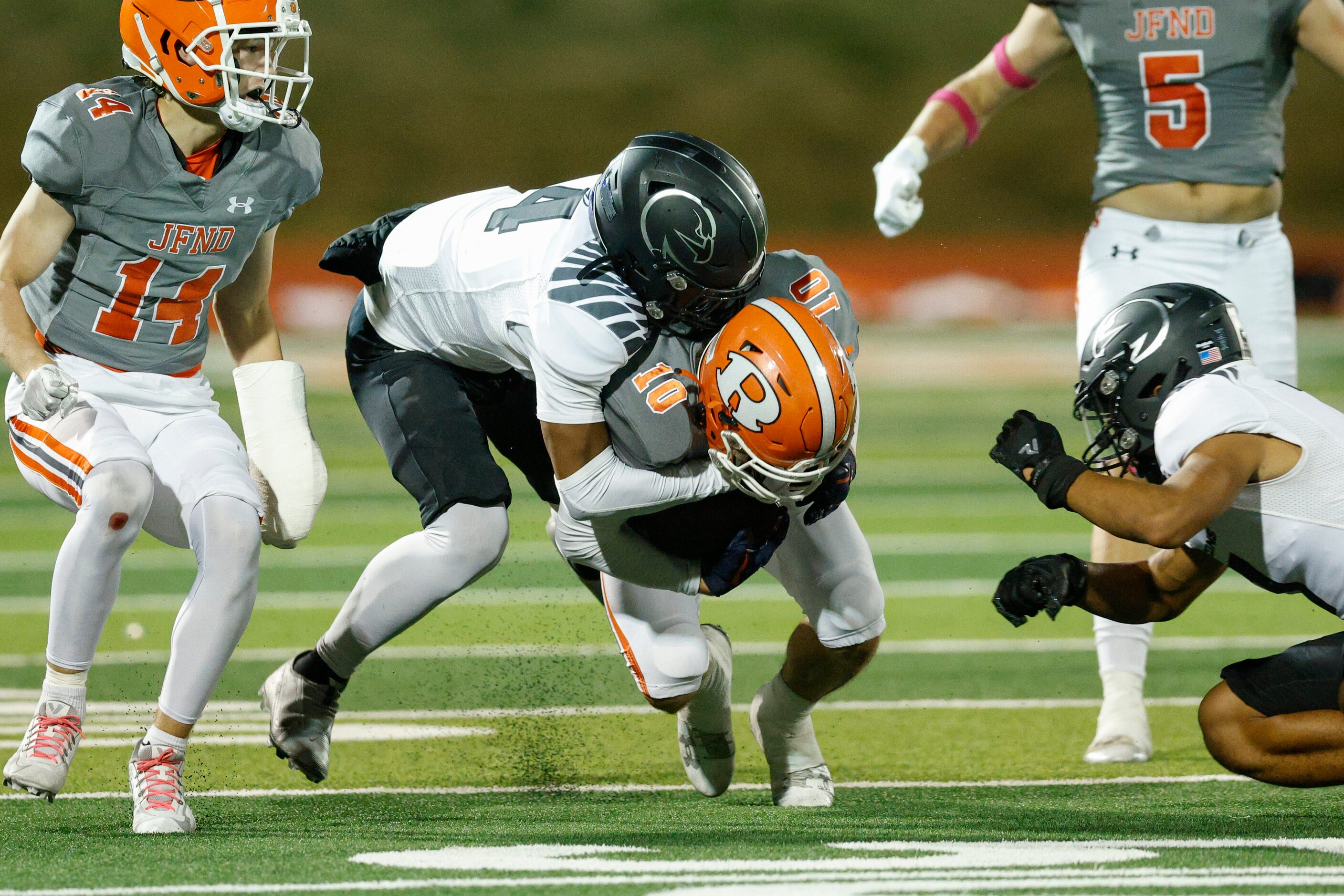 North Forney wide receiver Karen McCoy (4) tackles Rockwall defensive back Jake Brewer (10)...