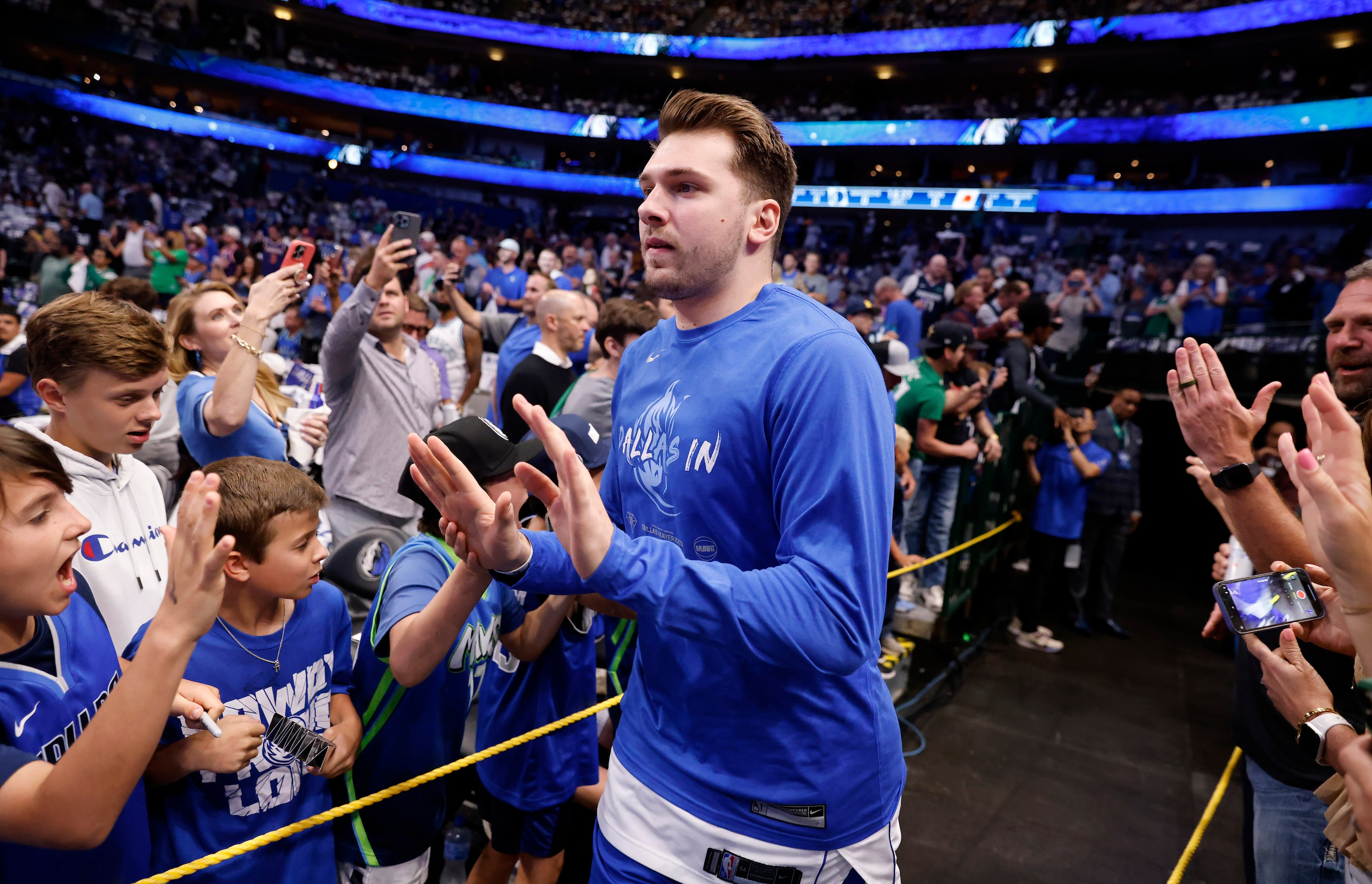 Dallas Mavericks guard Luka Doncic (77) races onto the court to face the Phoenix Suns in...