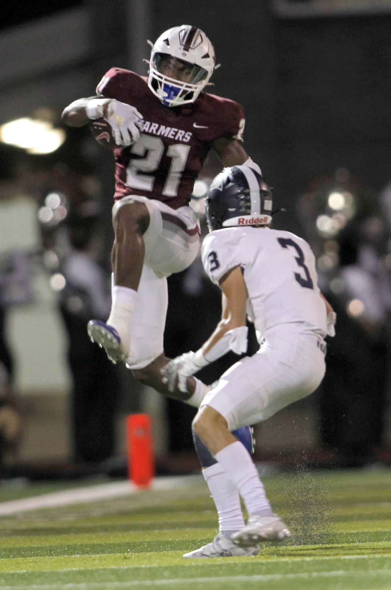 Lewisville running back Viron Ellison (21) leaps in an attempt to avoid the defensive...