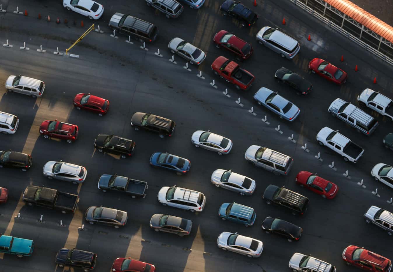 Cars wait in line to make their way into the United States through the U.S. Customs and...