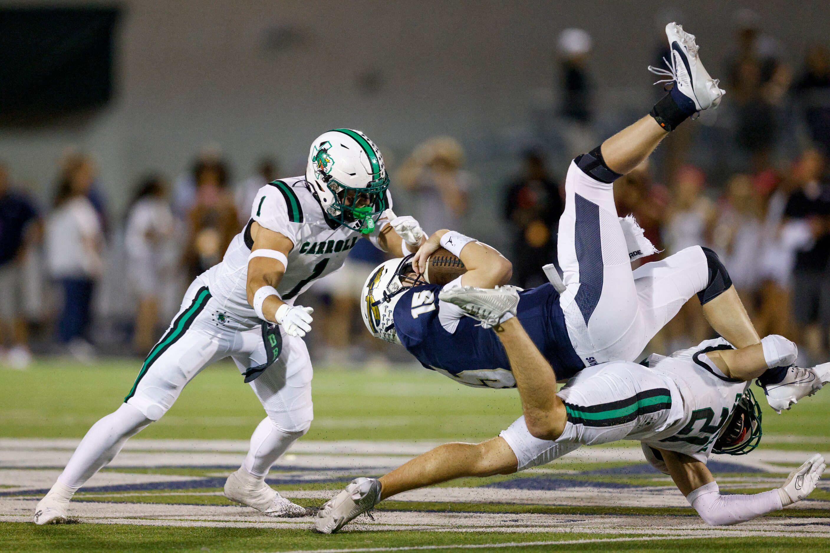 Southlake Carroll defensive back Zack Engelhardt (21) tackles Keller quarterback Beckham...