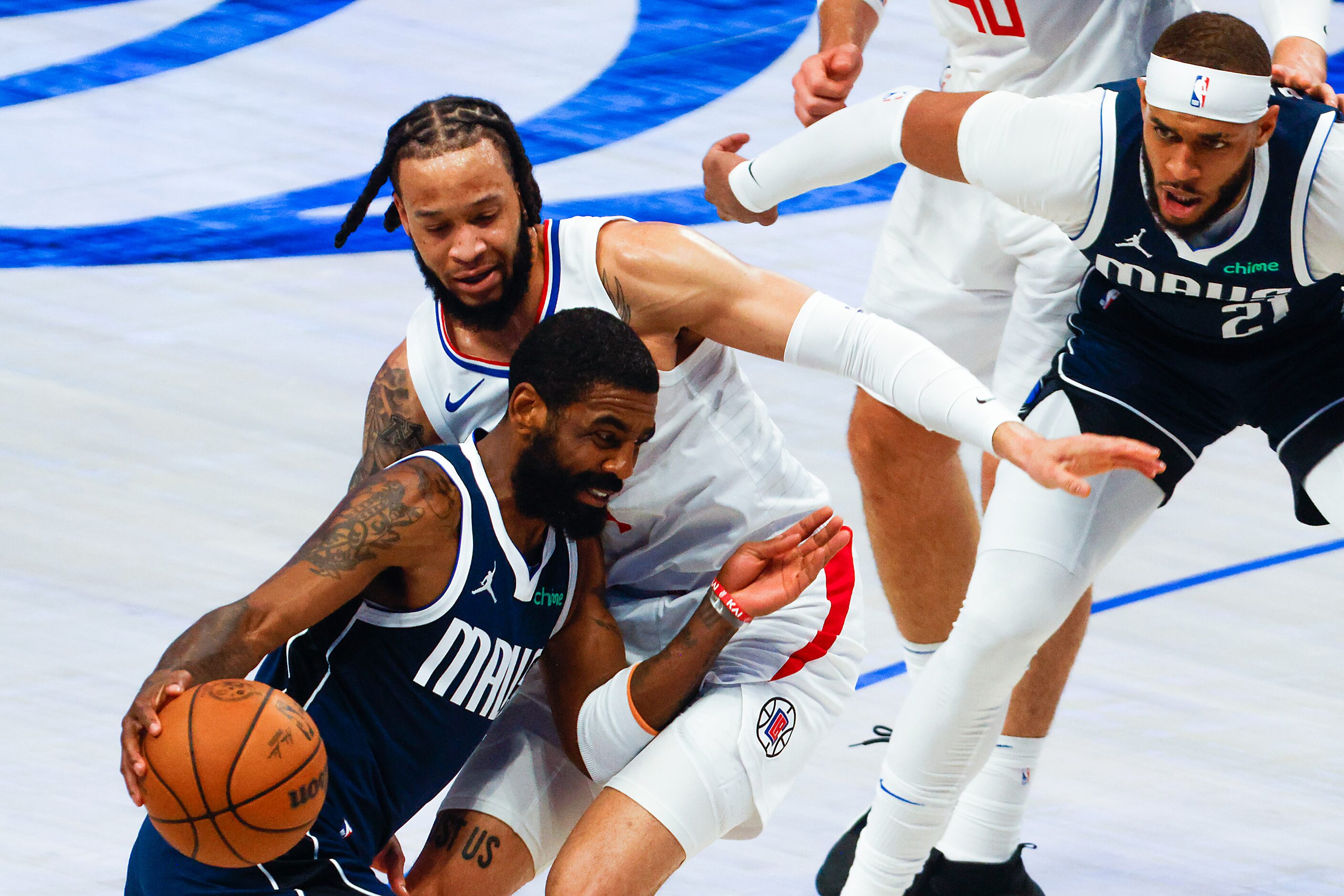 Dallas Mavericks guard Kyrie Irving drives LA Clippers guard Amir Coffey as Mavericks center...