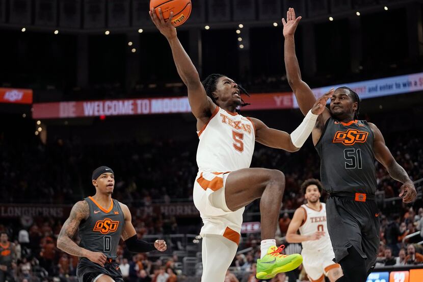 Texas guard Marcus Carr (5) drives to the basket against Oklahoma State guard John-Michael...