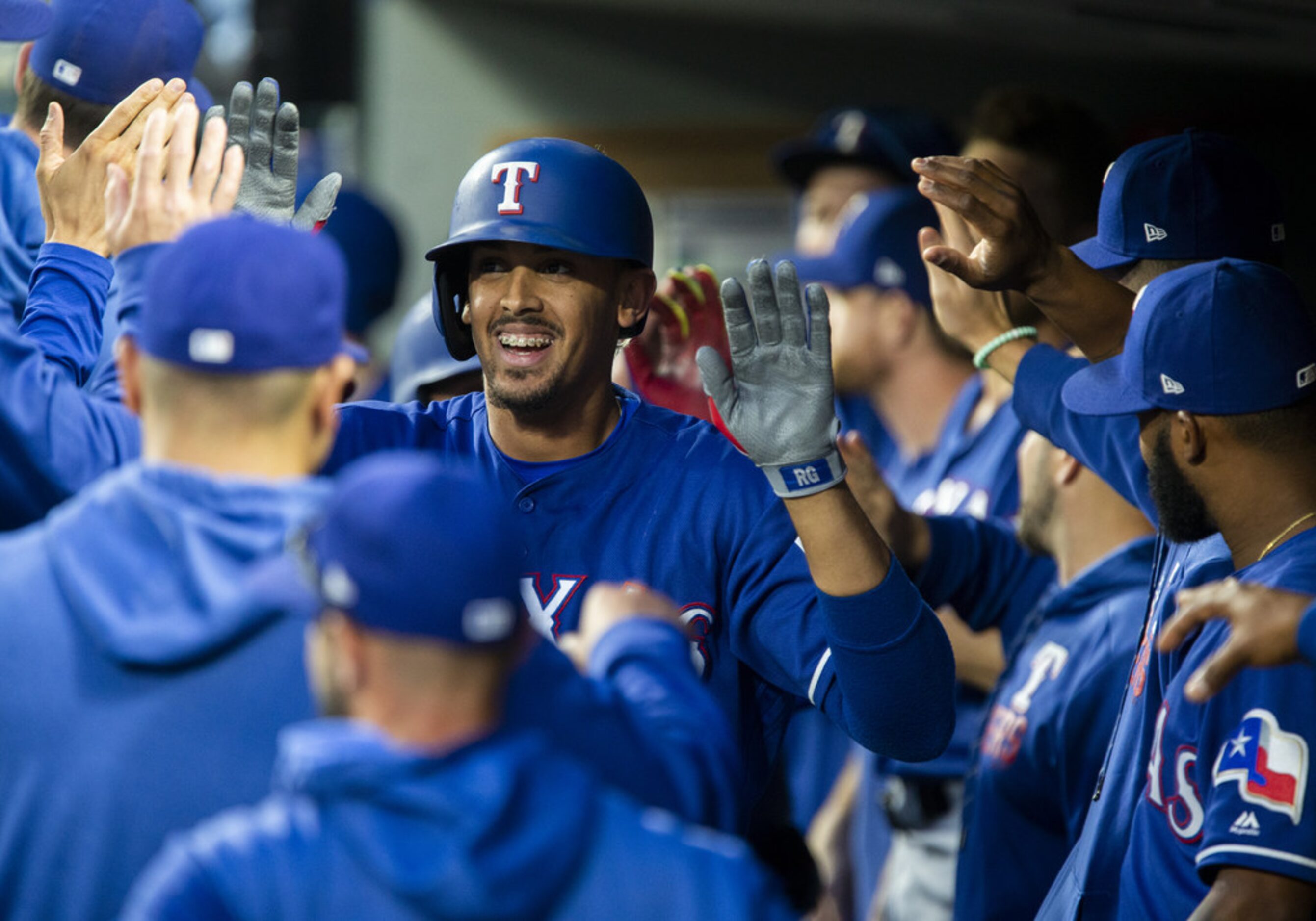 SEATTLE, WA - MAY 28:  Ronald Guzman #11 of the Texas Rangers smiles in the dugout as he...