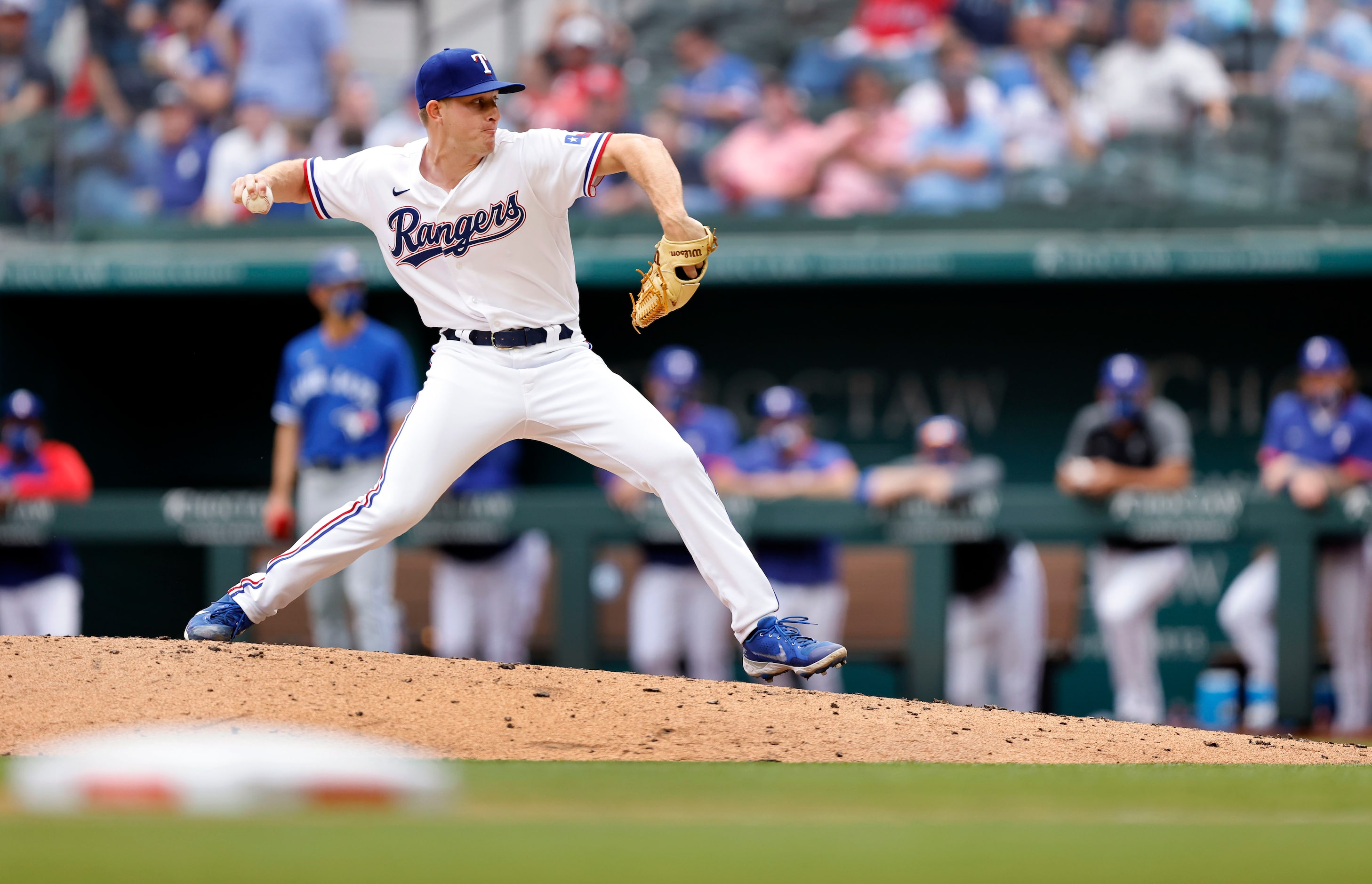 Texas Rangers relief pitcher Brett de Geus (56) throws against the Toronto Blue Jays during...