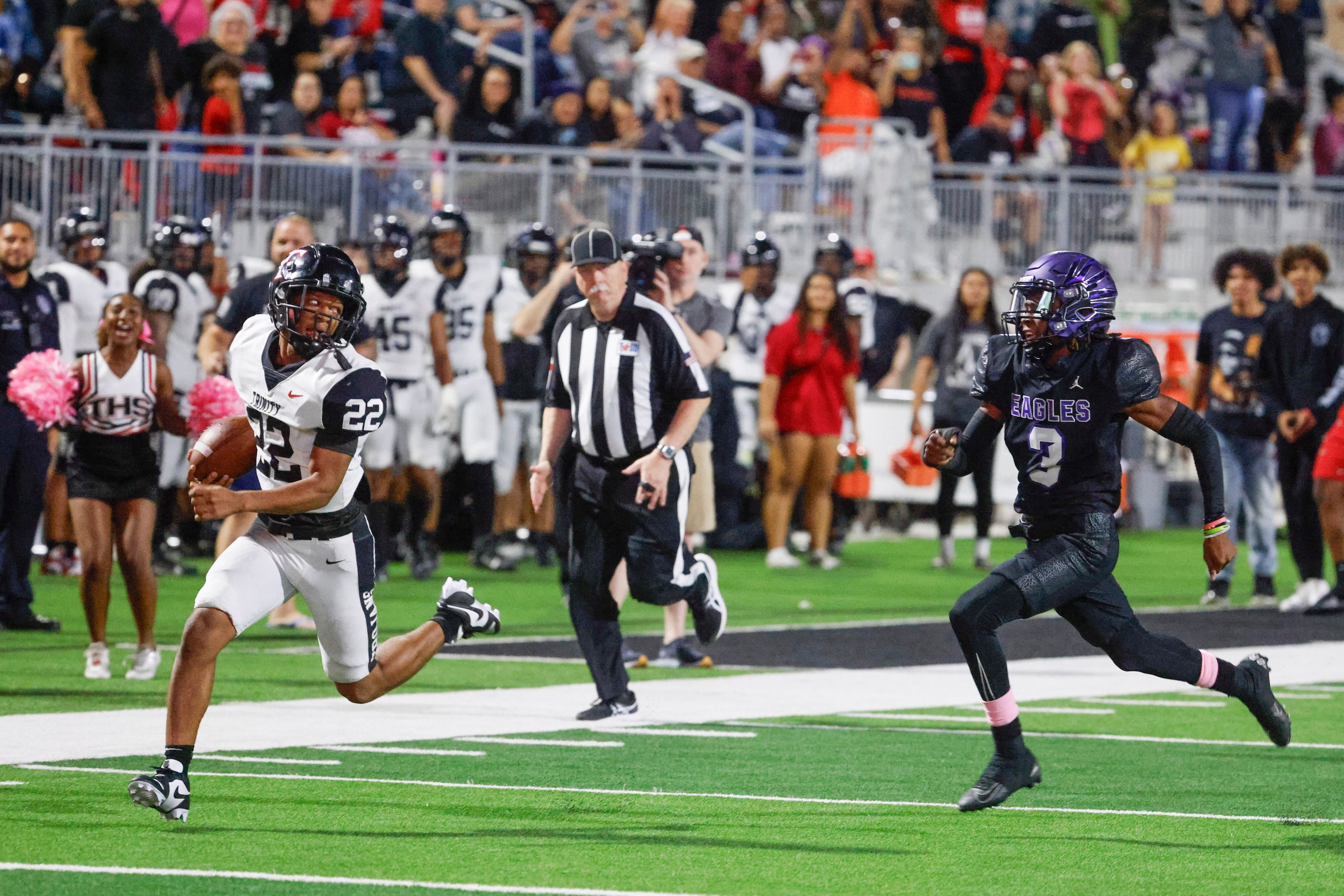 Trinity High’s JT Harris (left) looks back as he runs past Crowley High’s Ja’Corian White to...