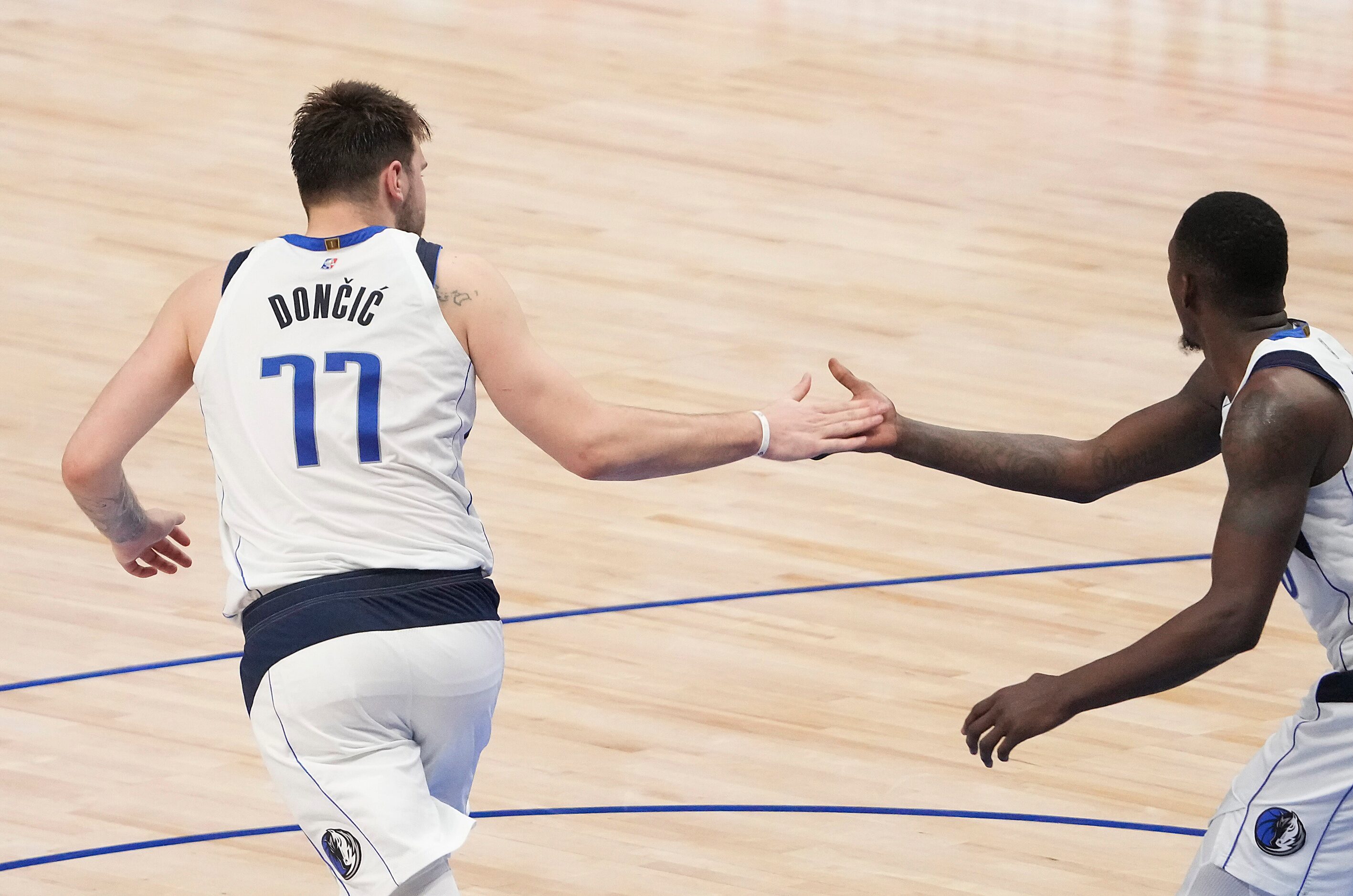 Dallas Mavericks guard Luka Doncic (77) celebrates a basket with forward Dorian Finney-Smith...