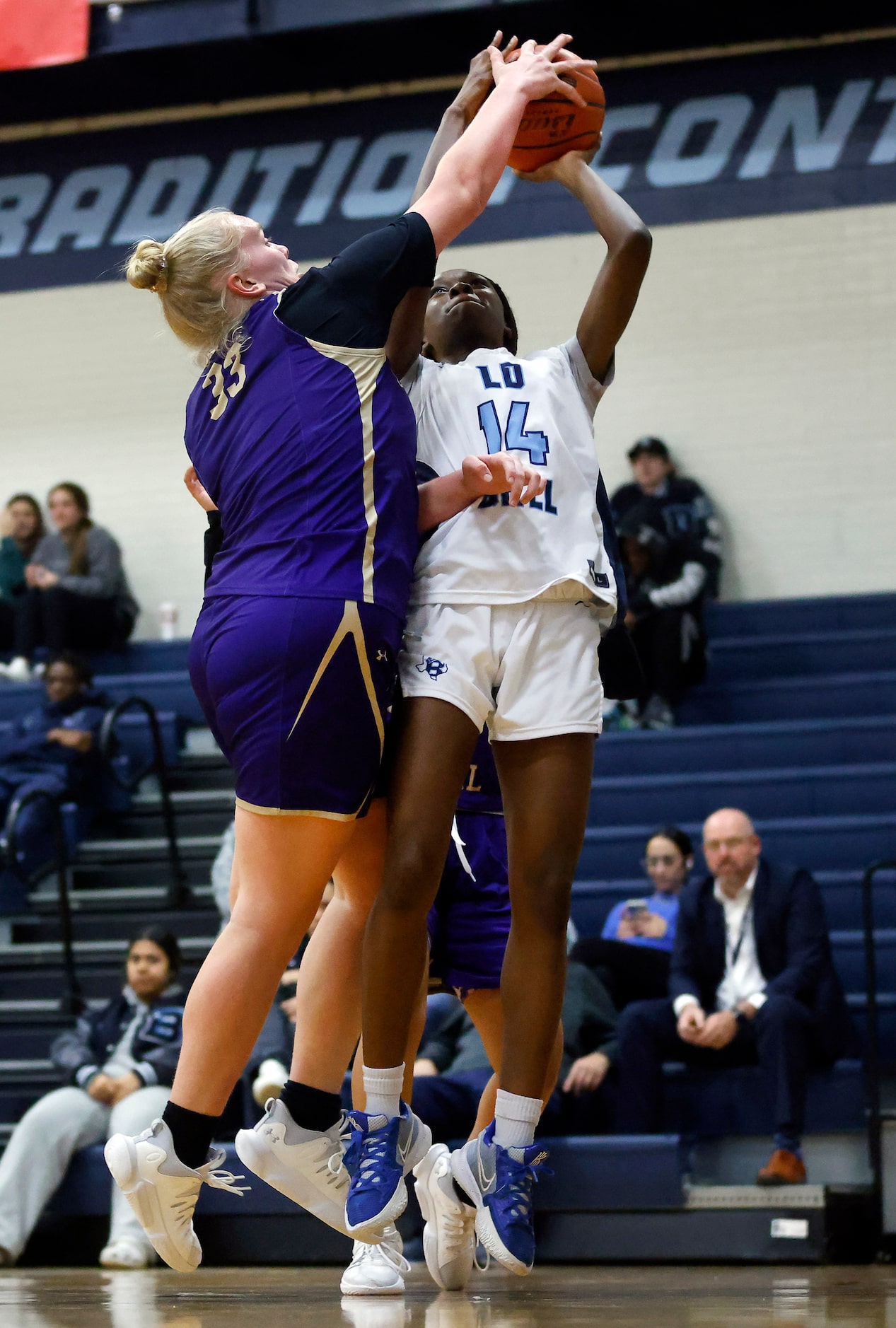 Hurst L.D. Bell’s Joyce Montcho (14) has her shot blocked by Saginaw Chisholm Trail’s...