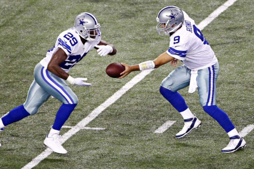 Dallas Cowboys quarterback Tony Romo (9) hands off to running back DeMarco Murray during the...