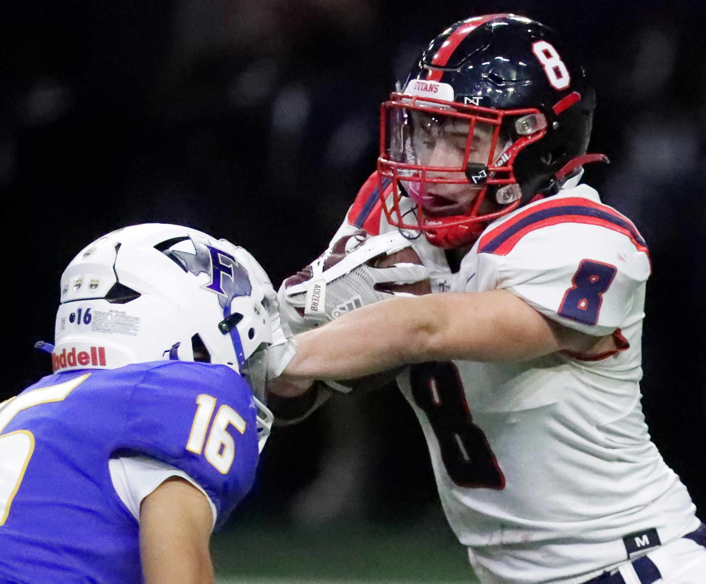 Centennial High School kick returner Adam Schmid (8) uses a stiff arm on Frisco High School...