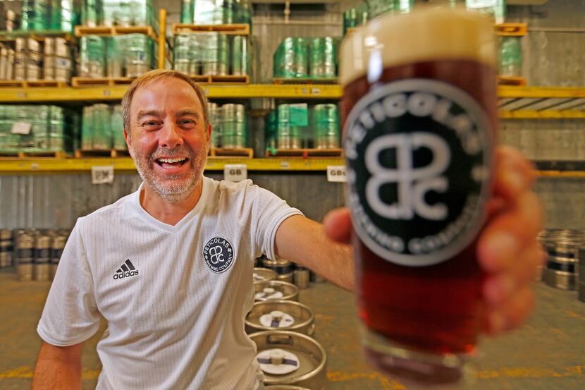 Owner Michael Peticolas poses for a photograph with beer at Peticolas Brewing Company in...