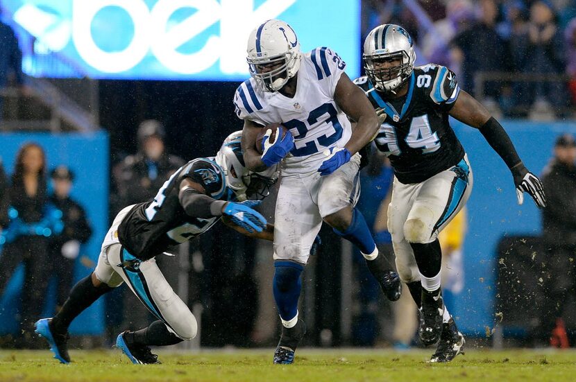  Josh Norman (left) of the Carolina Panthers dives to tackle Frank Gore of the Indianapolis...