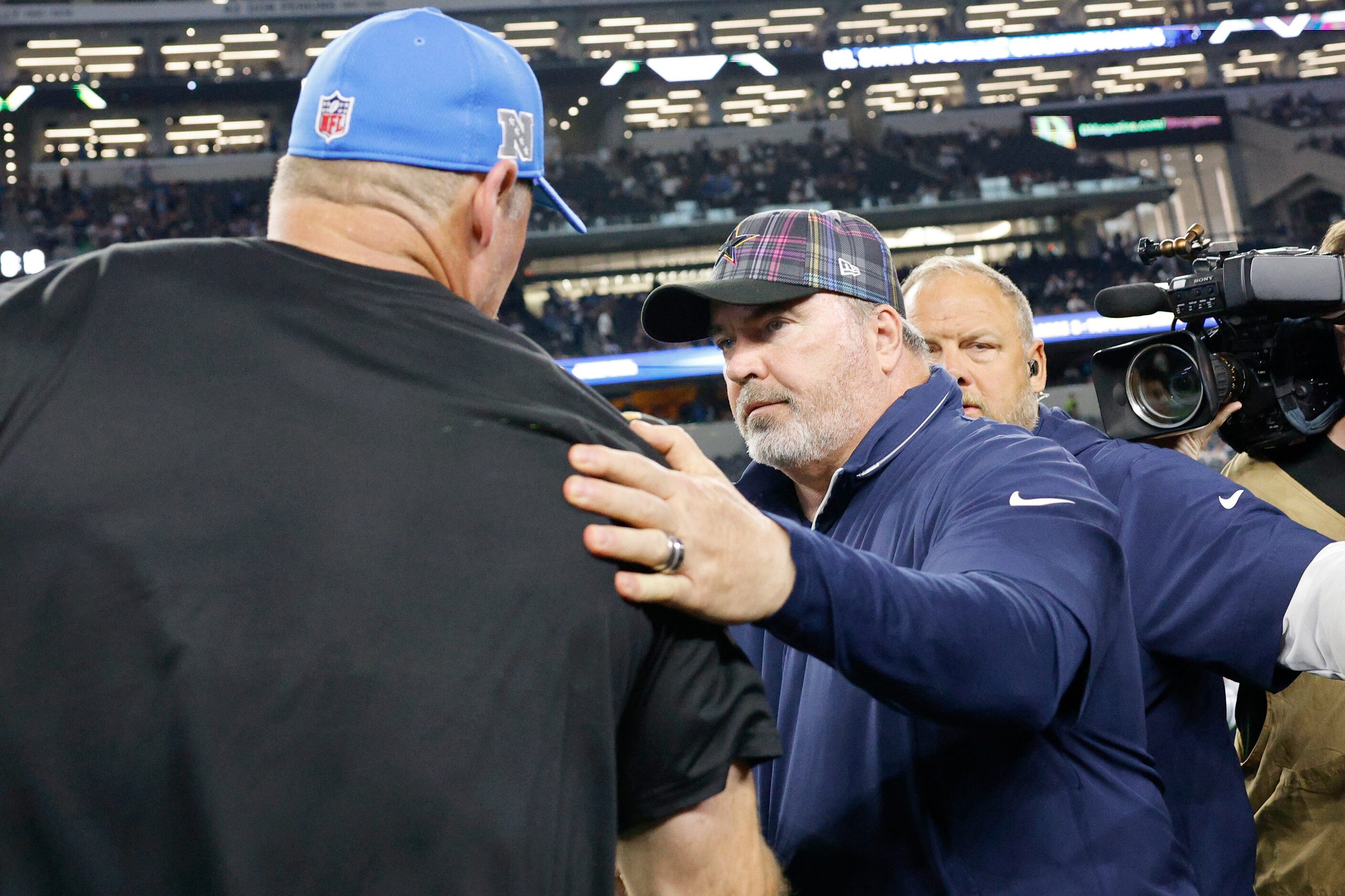 Dallas Cowboys head coach Mike McCarthy, right, greets Detroit Lions head coach Dan Campbell...