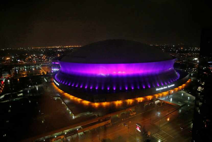 The Mercedes-Benz Superdome is lit up in the color purple in New Orleans, Thursday, April...