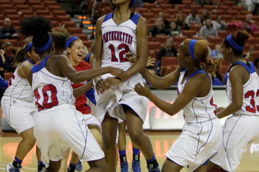 3/2/13  - Duncanville's Ariel Atkins (12) and teammates celebrate their victory over Cibolo...