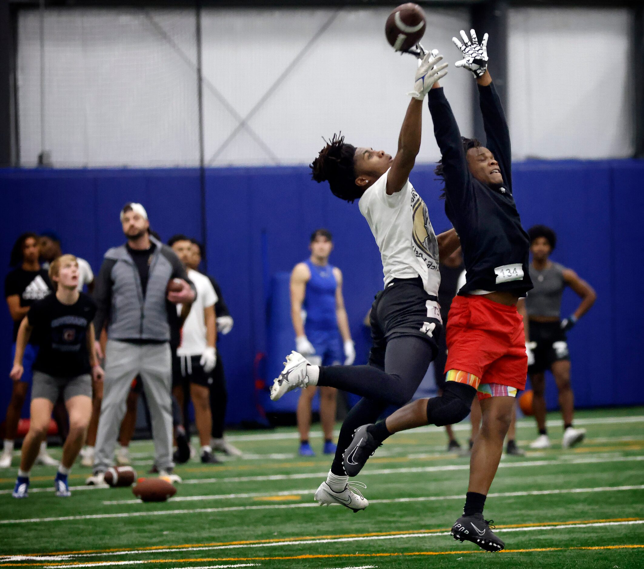 Unsigned senior defensive back King White of Harker Heights High School goes up for a pass...