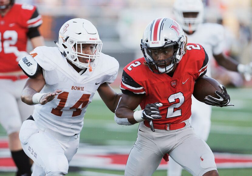 TXHSFB Flower Mound Marcus senior running back Justin Dinka (2) looks for room against...