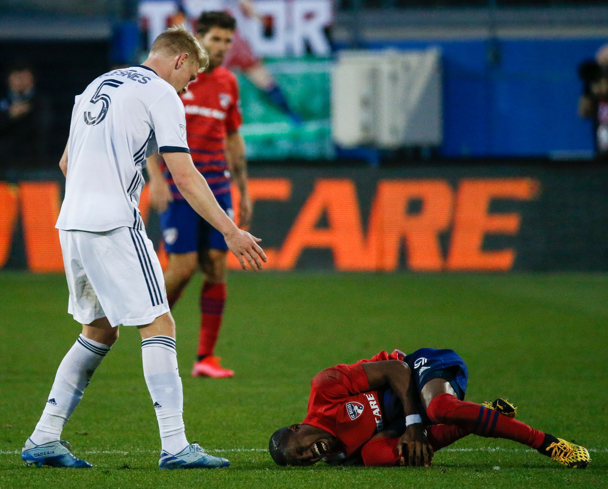FC Dallas attacker Fafa Picault (9) recovers from an apparent injury during the second half...