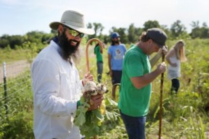  Trog Trogdon (left), with Daron Babcock, held a handful of turnips at the farm after the...