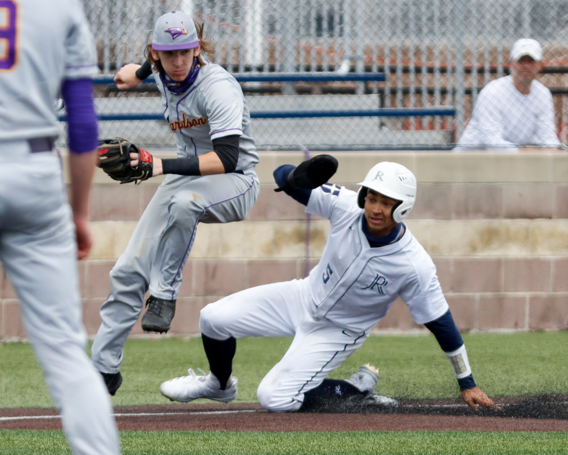 Richardson third baseman Jackson McDonald avoids a sliding Jesuit shortstop Jordan Lawlar...