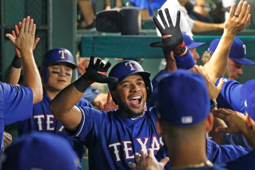 Texas Rangers shortstop Elvis Andrus (1) is congratulated by teammates after his home run in...