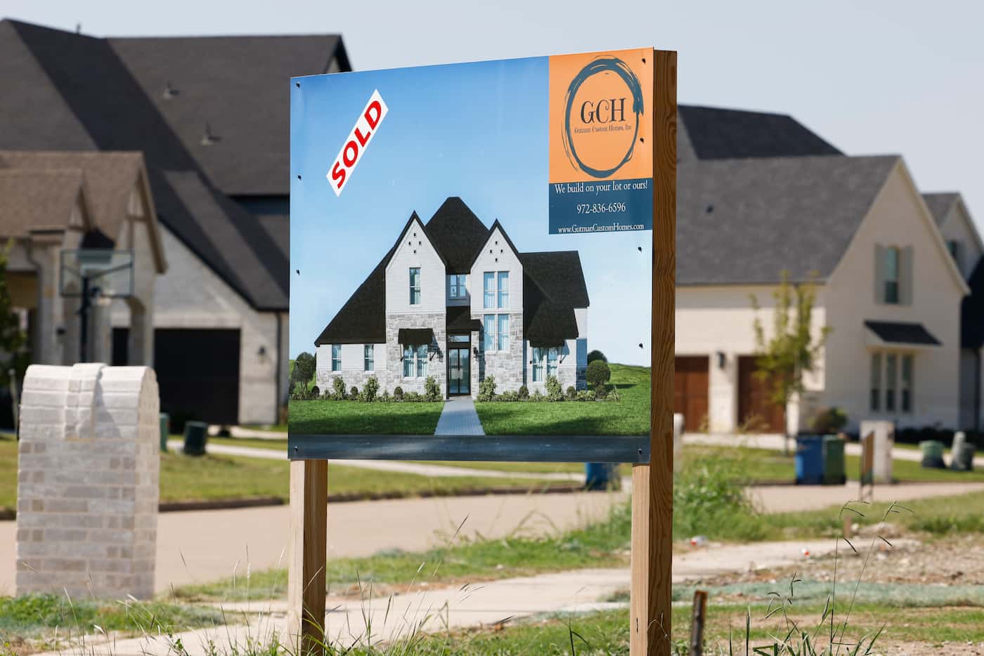 A sold sign is displayed outside a row of houses at the Bridges at Preston Crossing in Gunter.