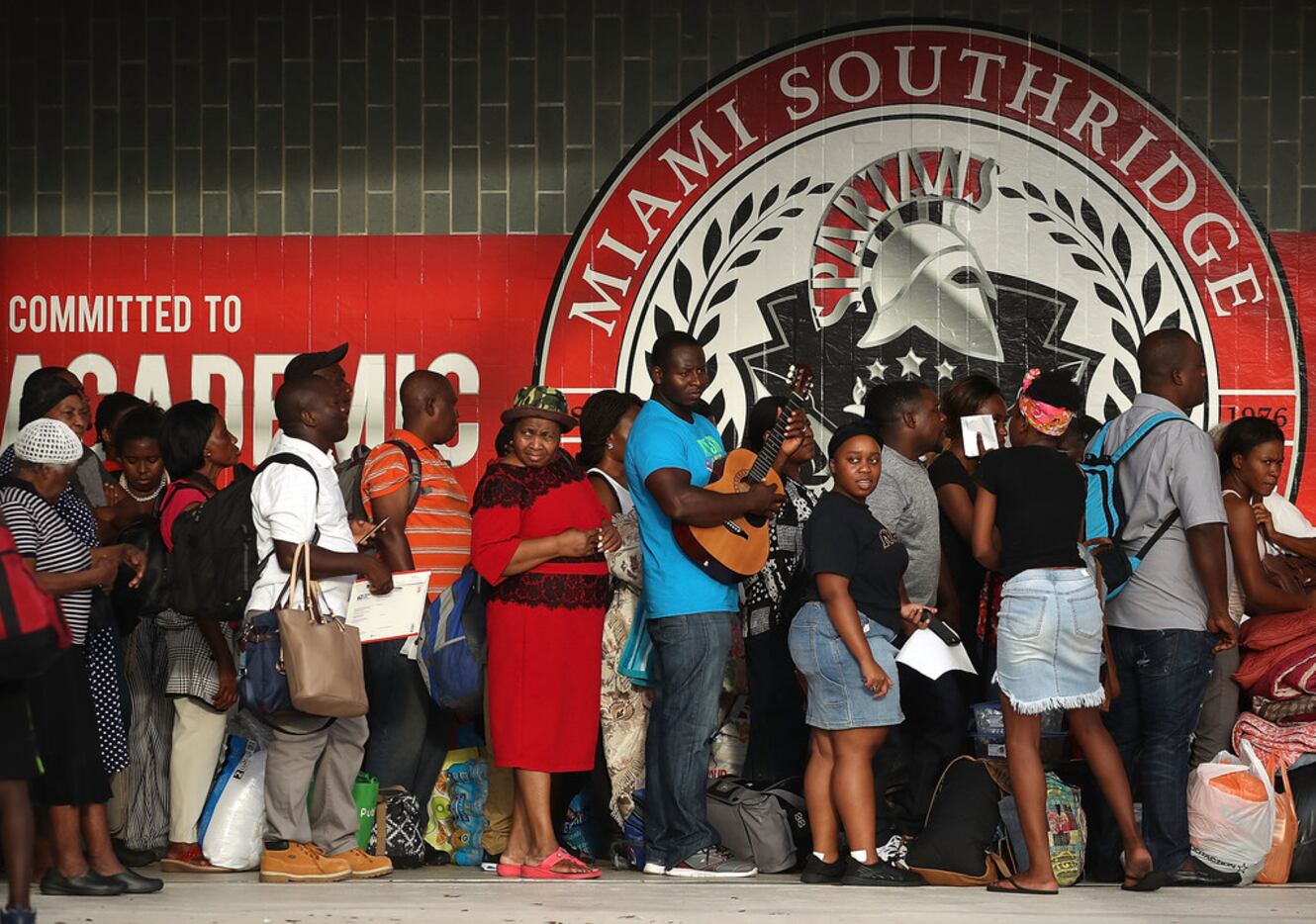People wait to enter Miami Southridge High School, which is being used as a shelter for...