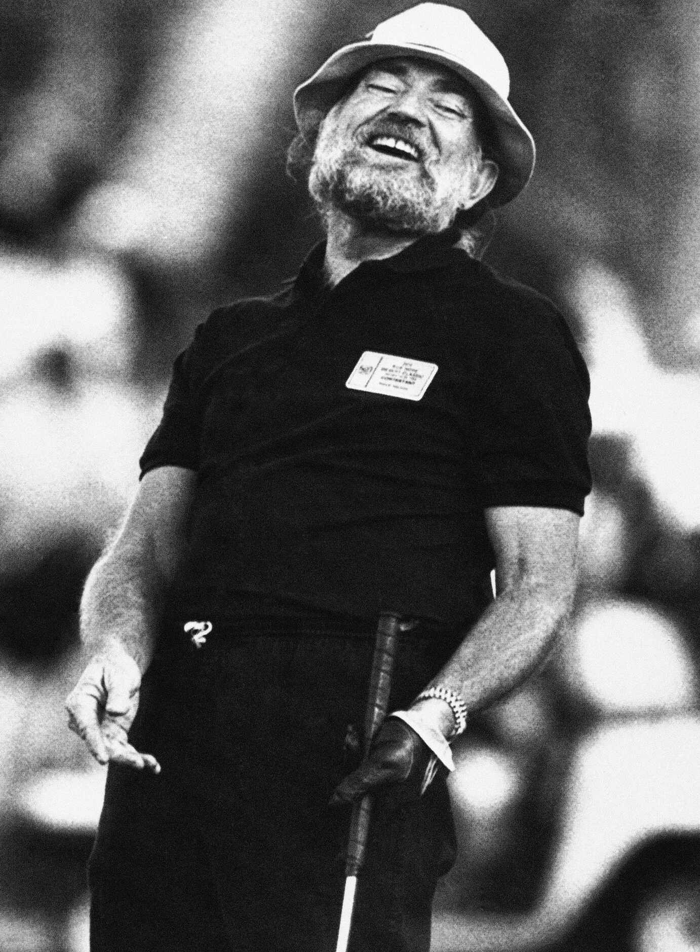 1983 - Willie Nelson reacts after sinking a 12-foot birdie putt at Indian Wells Country Club...