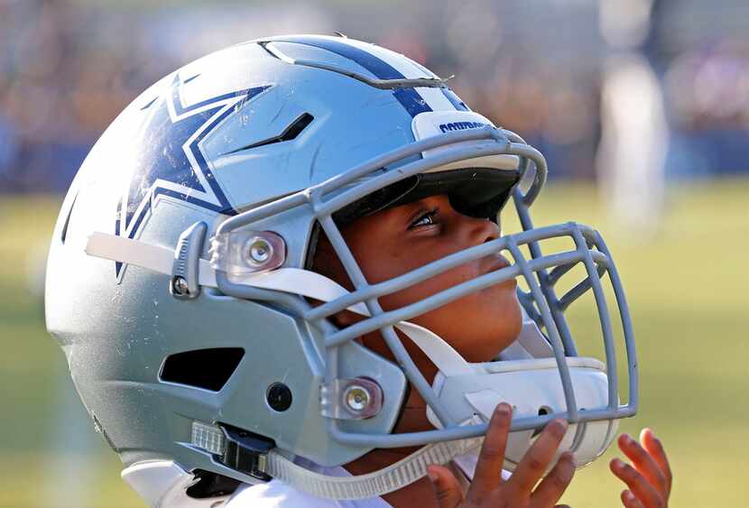 Laila Jones, daughter of Dallas Cowboys defensive end Datone Jones, gets her dad's helmet on...
