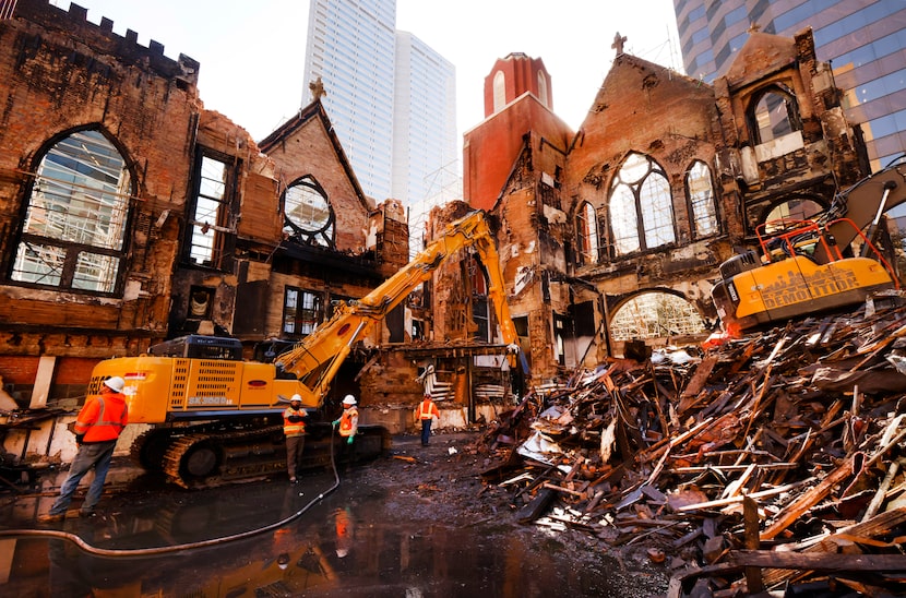 Demolition crews clean out the charred remains from First Baptist Dallas sanctuary fire from...