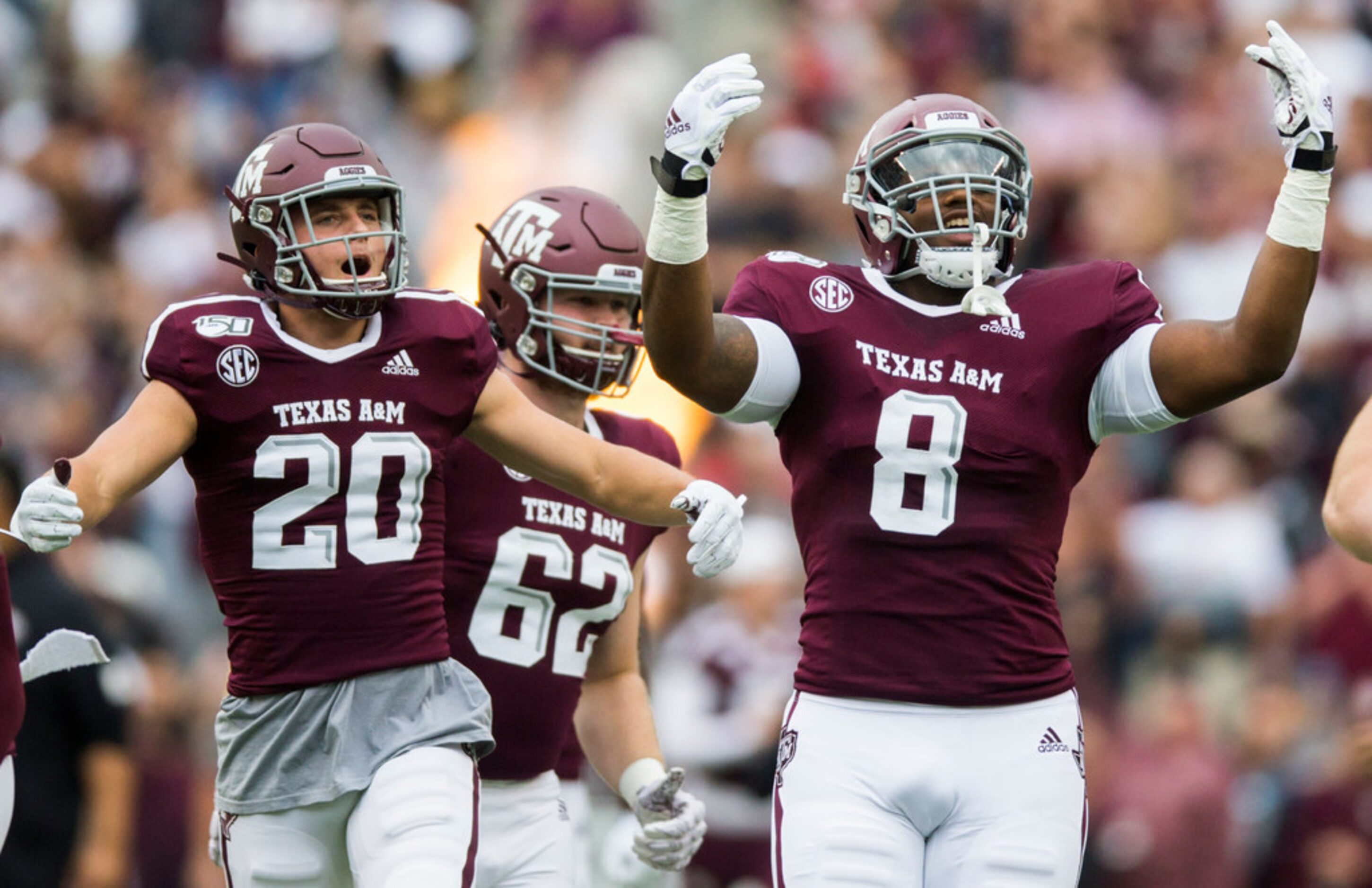 Texas A&M Aggies football players run out on the field before a college football game...