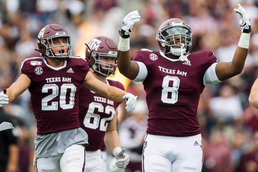 Texas A&M Aggies football players run out on the field before a college football game...