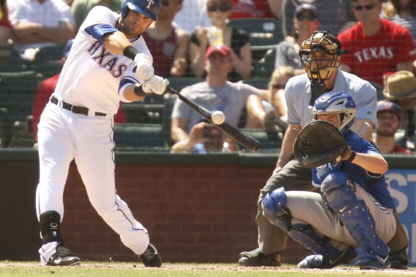 Texas first baseman Mitch Moreland swings on a two-run home run in the seventh inning during...