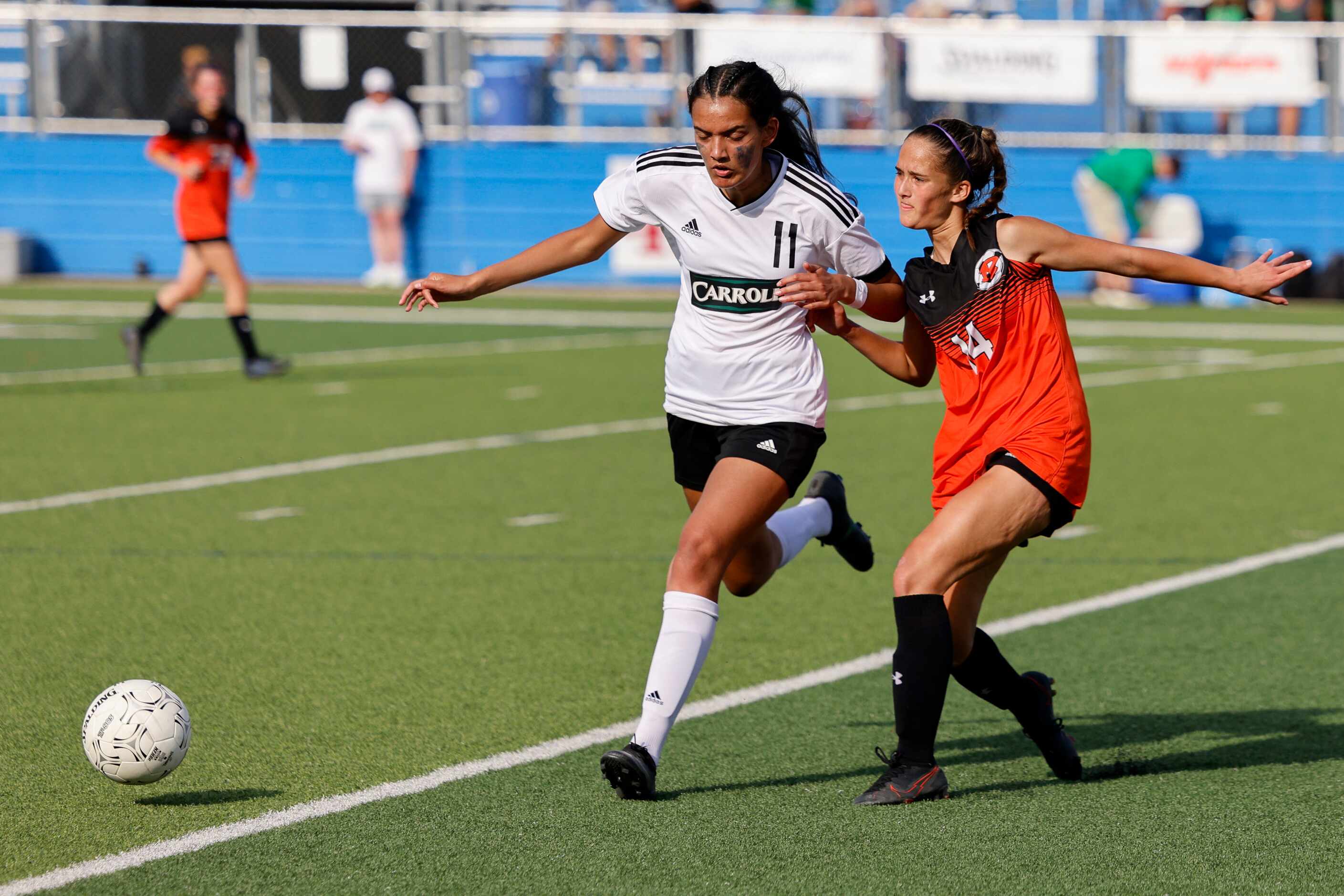 Southlake Carroll forward Ria Narayanan (11) battles with Rockwall defender Ayla Garcia (14)...