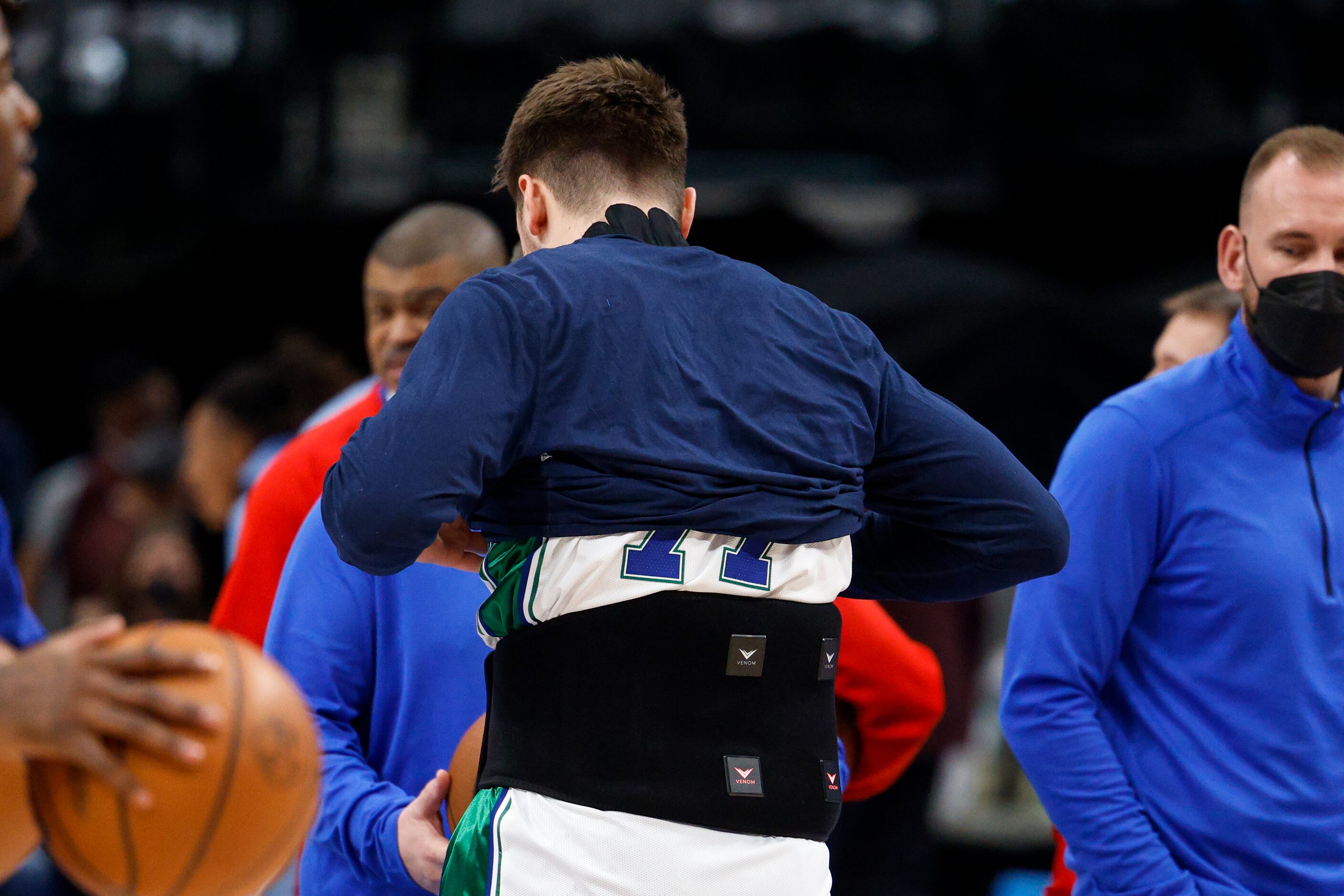 Dallas Mavericks guard Luka Doncic (77) puts on a heat pack before the first quarter against...