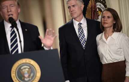 Judge Neil Gorsuch (C) and his wife Marie Louise look on, after US President Donald Trump...