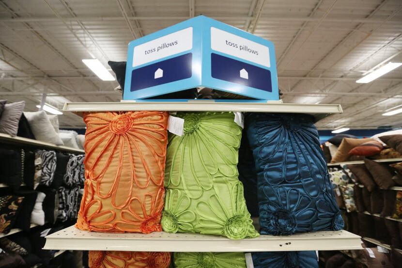 Various colored pillows sit on an end of an aisle inside an At Home location on Stemmons...