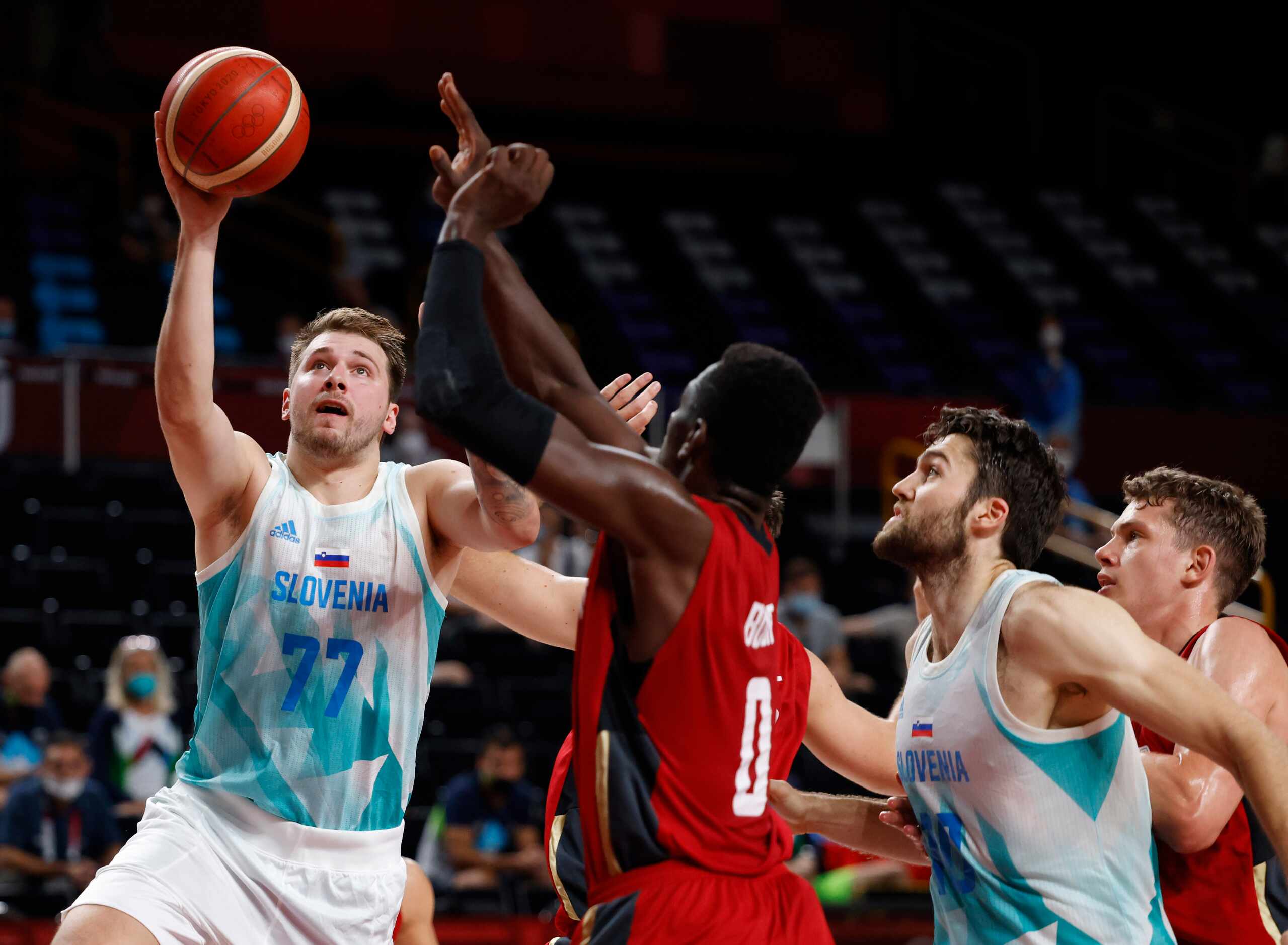 Slovenia’s Luka Doncic (77) attempts a shot on Germany’s Isaac Bonga (0) during the first...