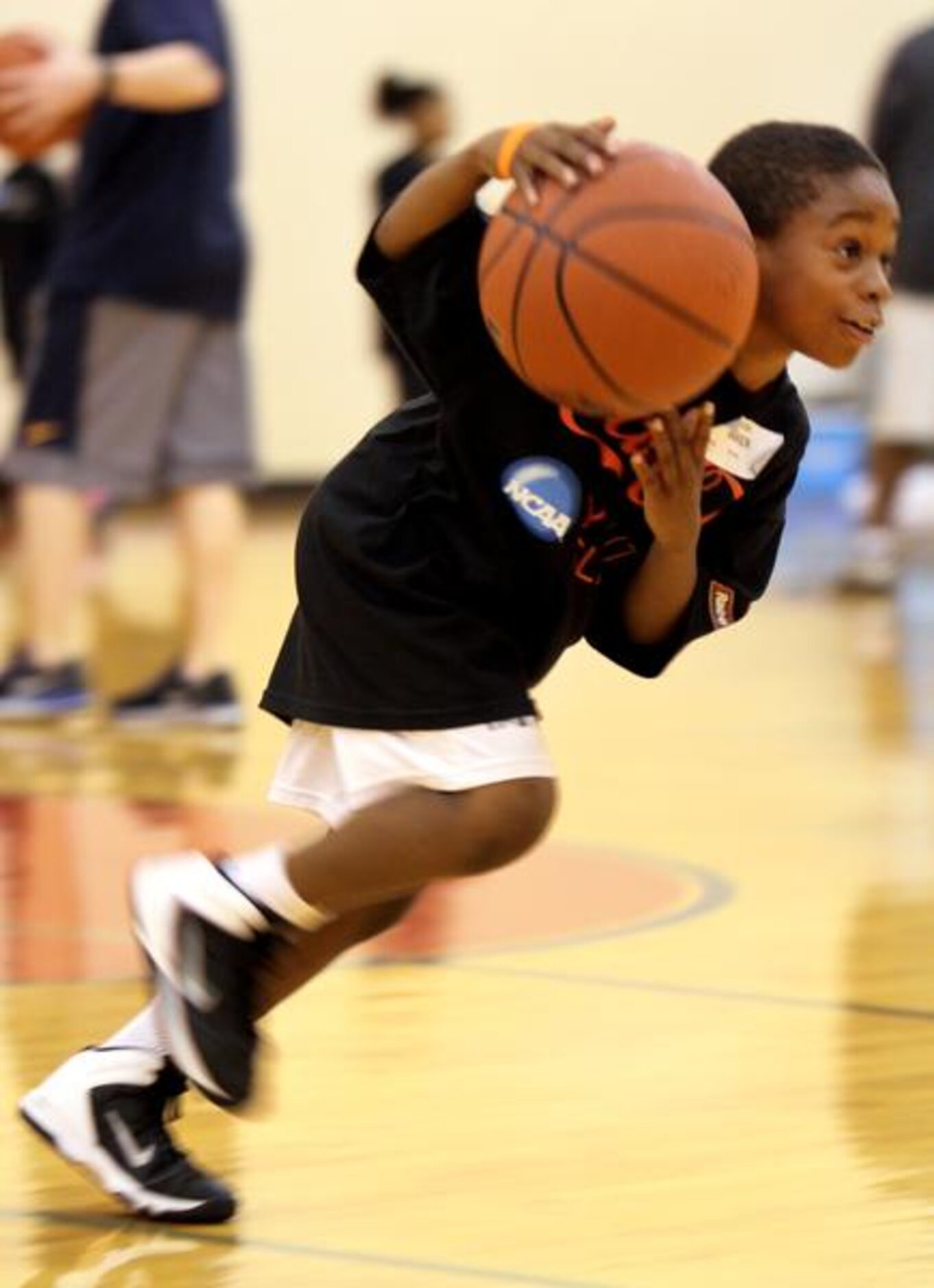 
Javon Baker, 8, of DeSoto, dribbles the ball across court as he was busy with other local...