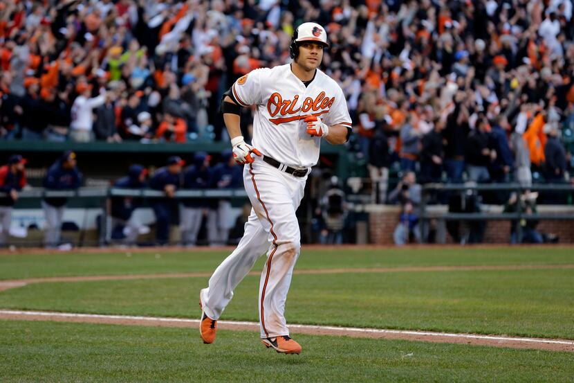 Baltimore Orioles designated hitter Chris Davis jogs down the first base line after hitting...