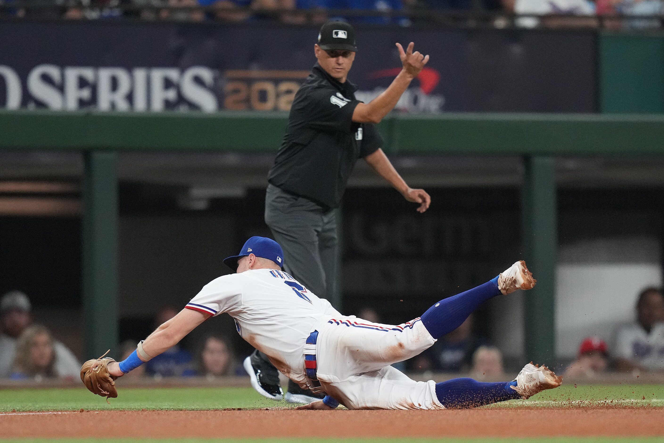 Texas Rangers third baseman Josh Jung makes a diving stop on a ground ball out by Arizona...