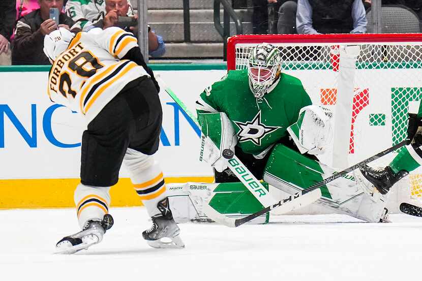 Dallas Stars goaltender Jake Oettinger (29) turns away a shot from Boston Bruins defenseman...