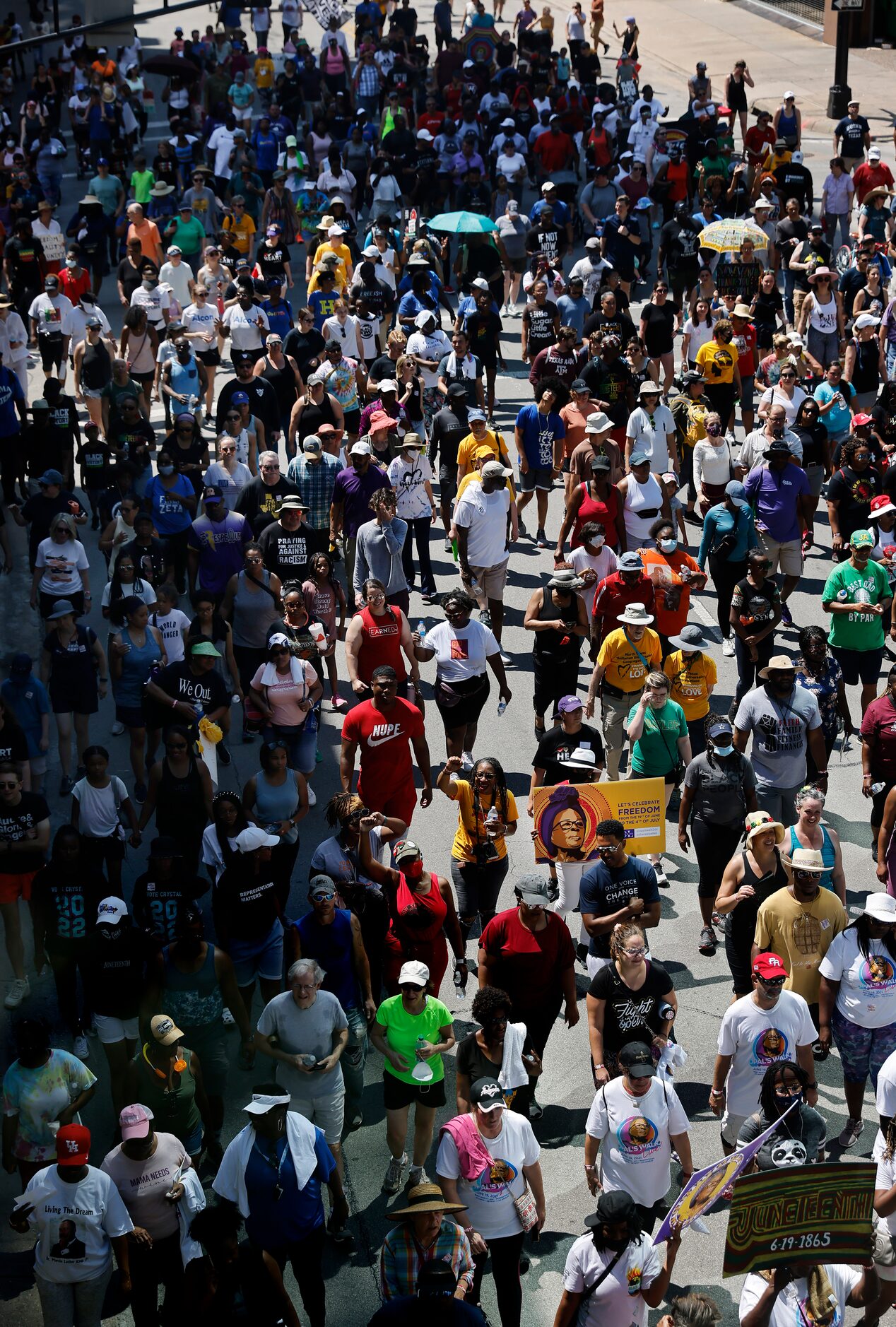 A large group of supporters follow Opal Lee down Commerce St. during her Juneteenth walk...