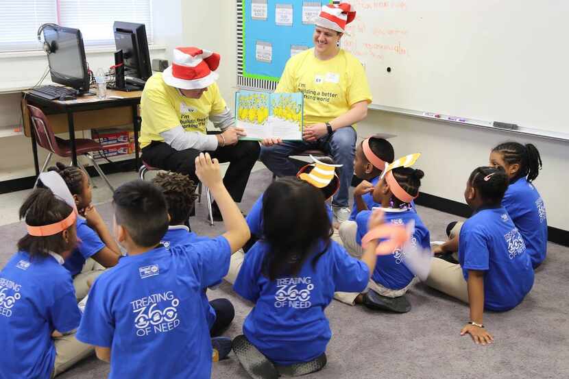 two adults reading to a group of kids on Dr Seuss Reading Day, National Read Across America Day