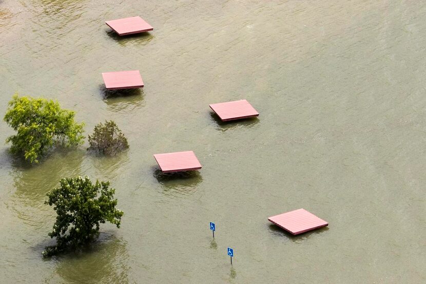 
Floodwaters from Joe Pool Lake cover picnic shelters in Cedar Hill State Park on May 29...