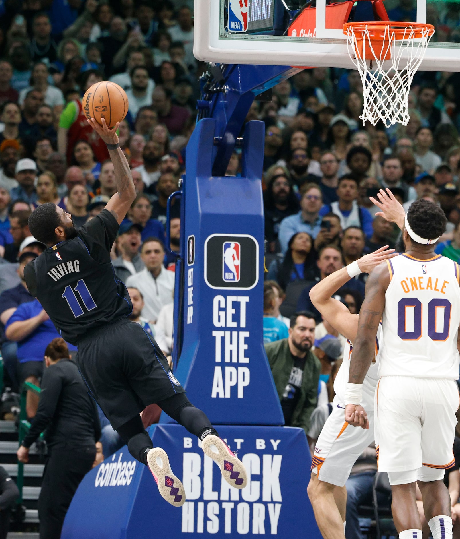 Dallas Mavericks guard Kyrie Irving (11) shoots during the first half of an NBA basketball...