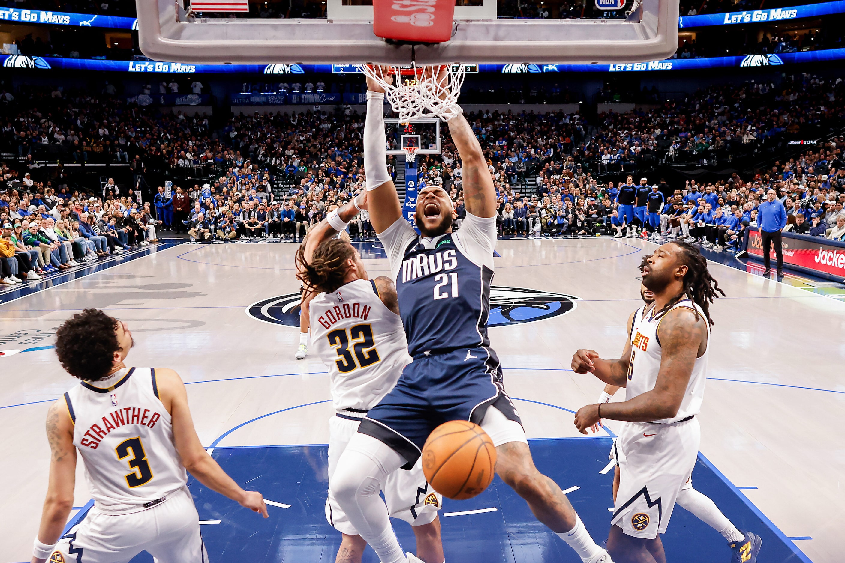 Dallas Mavericks center Daniel Gafford (21) dunks the ball past Denver Nuggets guard Julian...