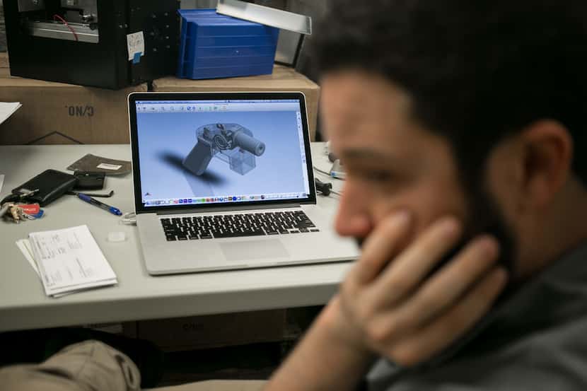 Cody Wilson with 3-D printer gun plans in Austin on May 4, 2015. Wilson is engaged in a...