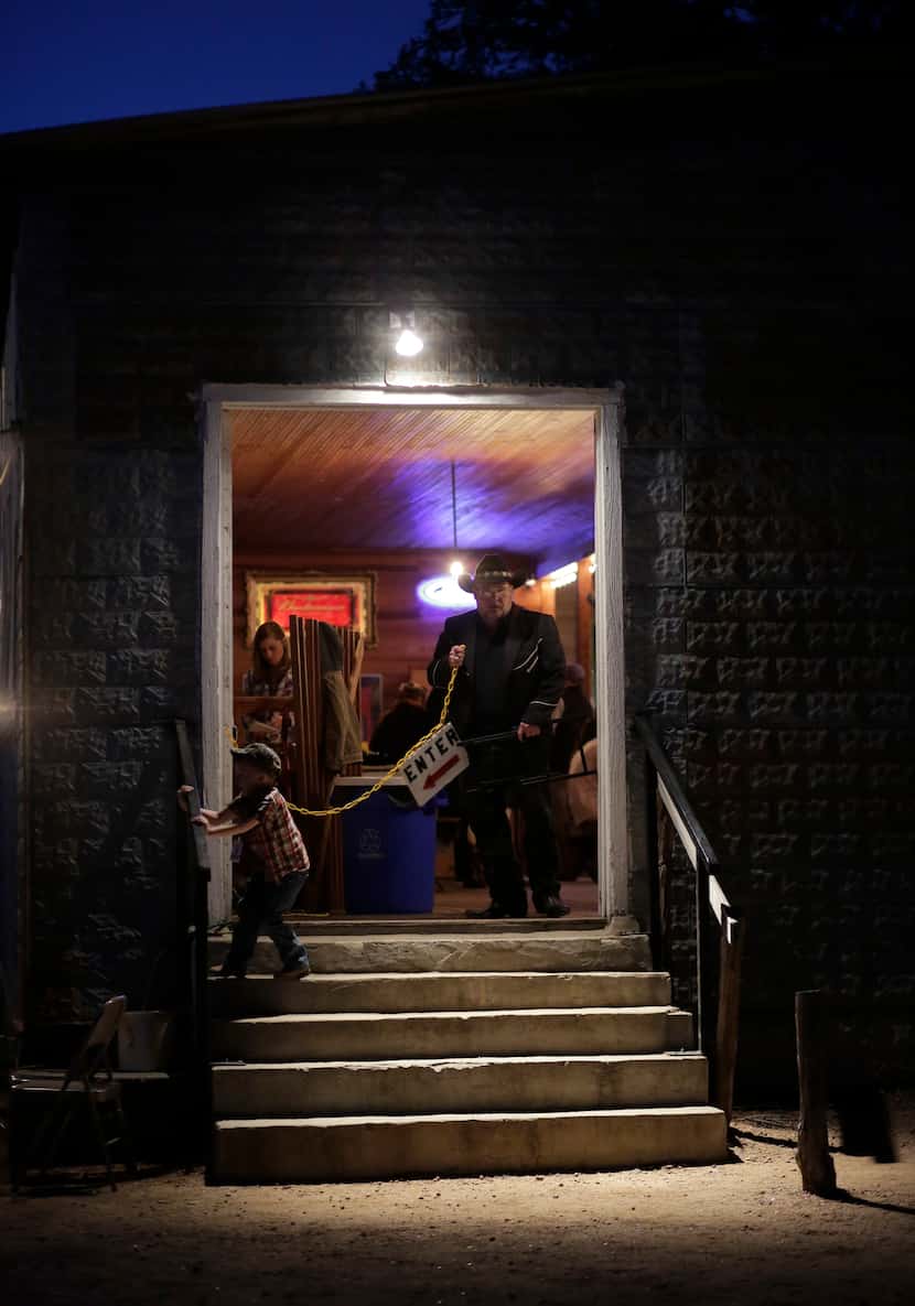 In this Dec. 6, 2014, photo, patrons exit Twin Sisters Dance Hall in Blanco, Texas. A...